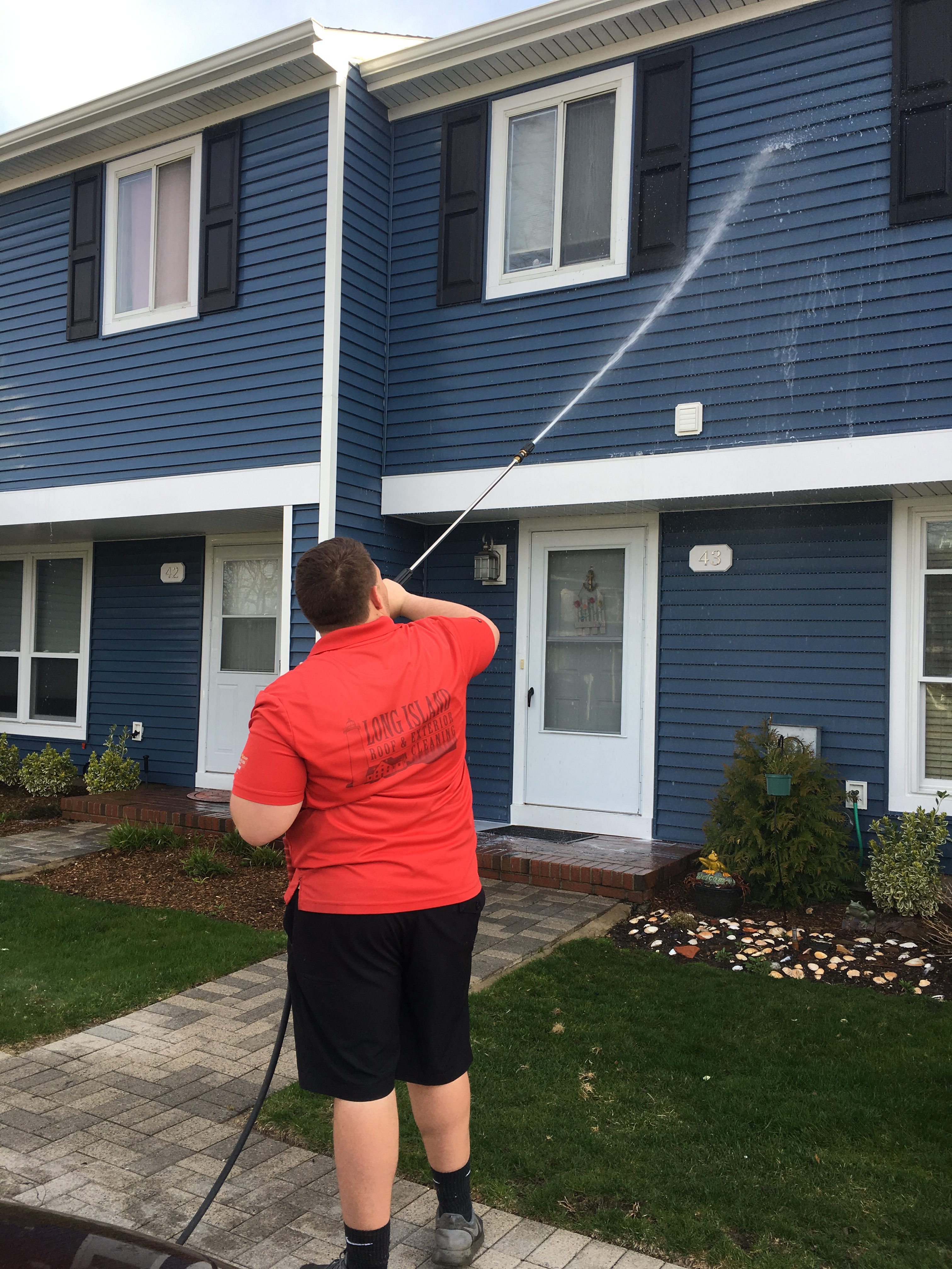 Power washing cleaning the exterior of an apartment complex or HOA